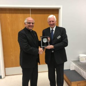 President Harvey Granatier presents appreciation gift to Father Tonny Dizy.