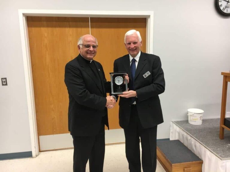 President Harvey Granatier presents appreciation gift to Father Tonny Dizy.