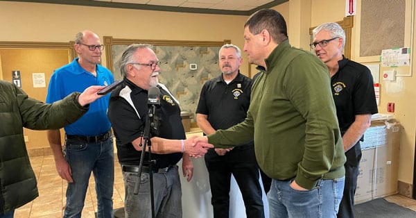 Saskatoon Tribal Council chief, Mark Arcand (center), with representatives from the local Knights of Columbus organization, receiving two large donated freezers. (Saskatoon Tribal Council/Submitted)