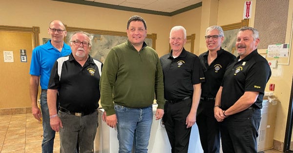 Saskatoon Tribal Council chief, Mark Arcand (center), with representatives from the local Knights of Columbus organization, receiving two large donated freezers. (Saskatoon Tribal Council/Submitted)