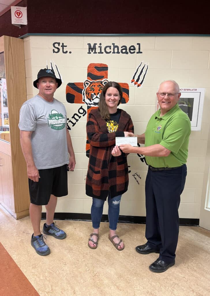 L To R: Council 1731 member Brother Chad Klein (teacher at St. Mike's), Principal of St. Mike's, Sabrina Gulka, and Council 1731 Grand Knight, Richard Wick. The cheque presented was for 0.00.
