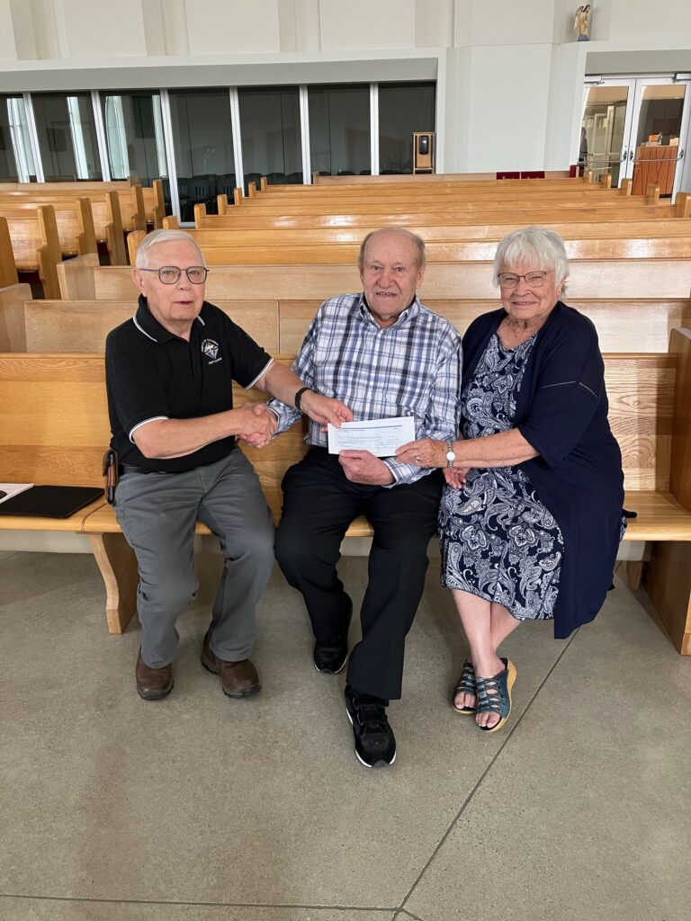 Grand Knight Gord Hagan from Swift Current Council 3031 with James & Elma Meier