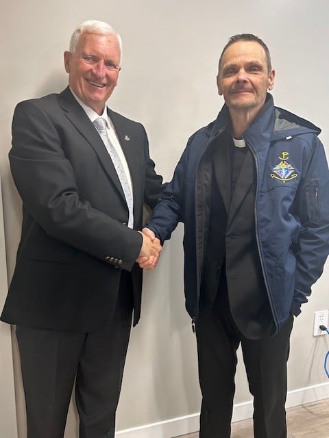 CEO  Harvey Granatier presented Chaplain Father Greg Elder with his Chaplain Jacket.