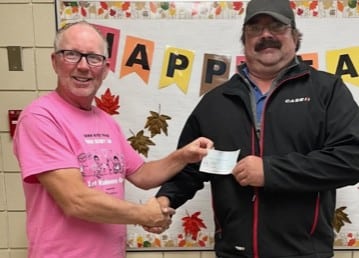 Bro Mitchel Staszczak, Membership Director, presents the cheque to a Wadena Elementary School Teacher