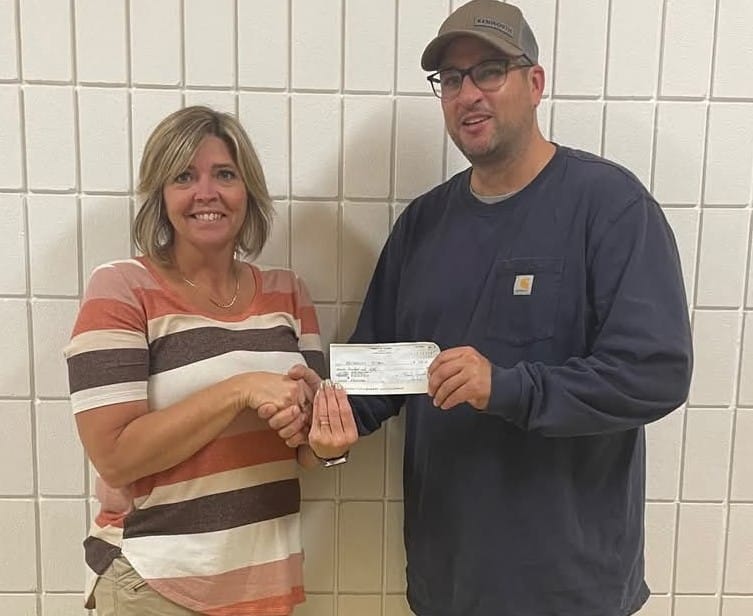 Bro Steven Gutek, Council Culture of Life Director, presents the check to the Principal of the Archerwill School