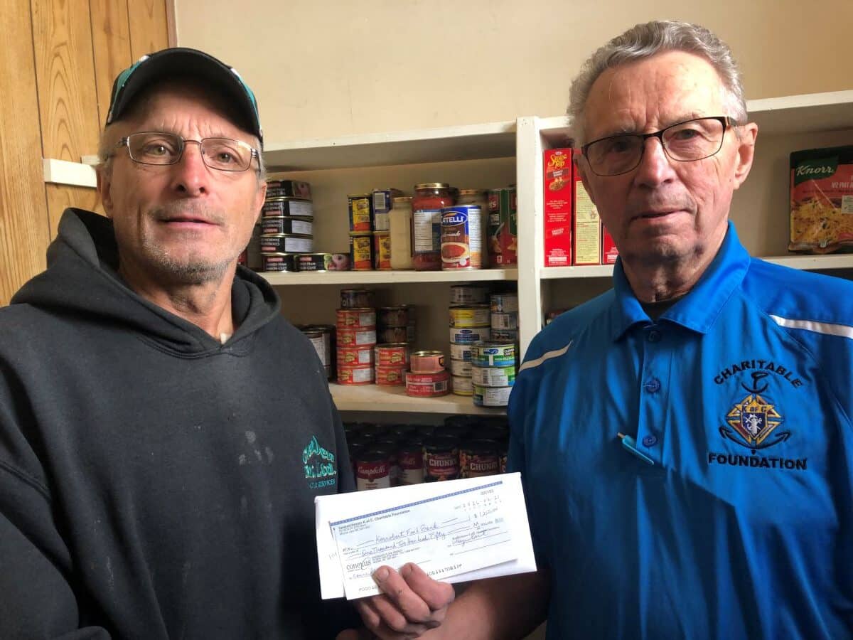 Calvin Ressler, Past Grand Knight and representative of the Kerrobert Food Bank received the check from Marvin DeSchryver PSD and representative of the Sask. K of C Charitable Foundation