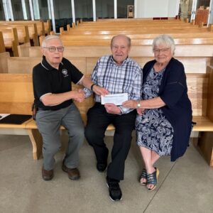 Grand Knight Gord Hagan from Swift Current Council 3031 with James & Alma Meier