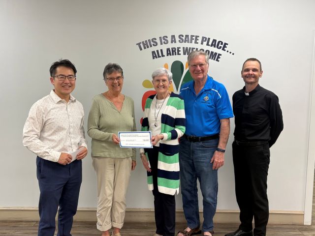 Adrienne & Mervyn Welter Education Endowment Fund makes a presentation 1 Mervyn and Adrienne Welter, representing the Saskatchewan Knights of Columbus Charitable Foundation and the Adrienne & Mervyn Welter Education Endowment Fund, along with Father Greg, Chaplain on the Charitable Foundation Board, presenting a $3,500 grant to CFS Battlefords. The grant was graciously accepted by Connie Carignan, Chairperson of the CFS Battlefords Board of Directors, and Chad Ku, Acting Executive Director.